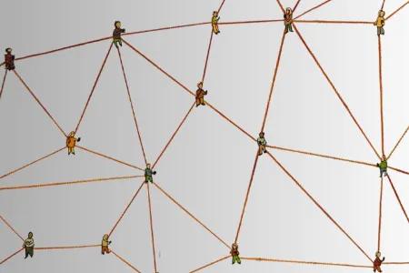 Several small cartoon representations of people are linked by brown handdrawn lines representing a network.